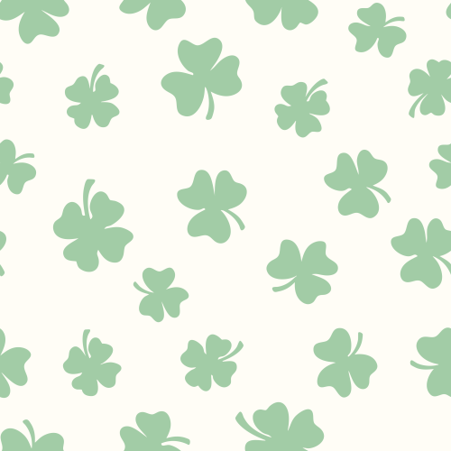 Green four-leaf clovers scattered on a cream background