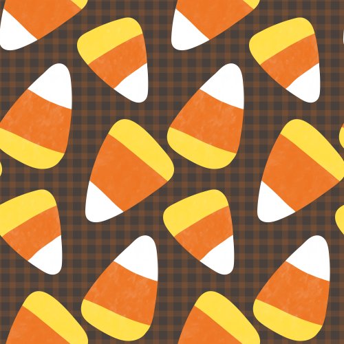 candy corn scattered on a plaid background